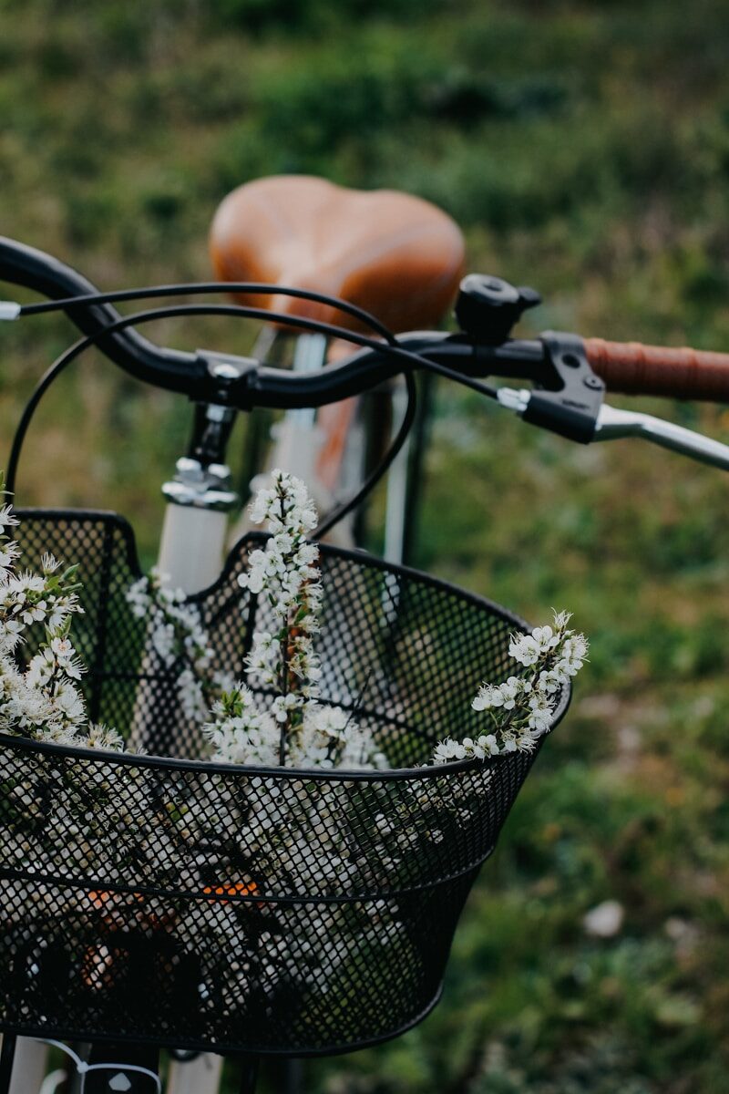 Photo by Nataliya Melnychuk a bicycle with a basket full of flowers